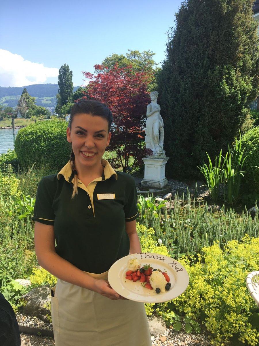 BHMS student in uniform working in food and beverage service at a Swiss hotel