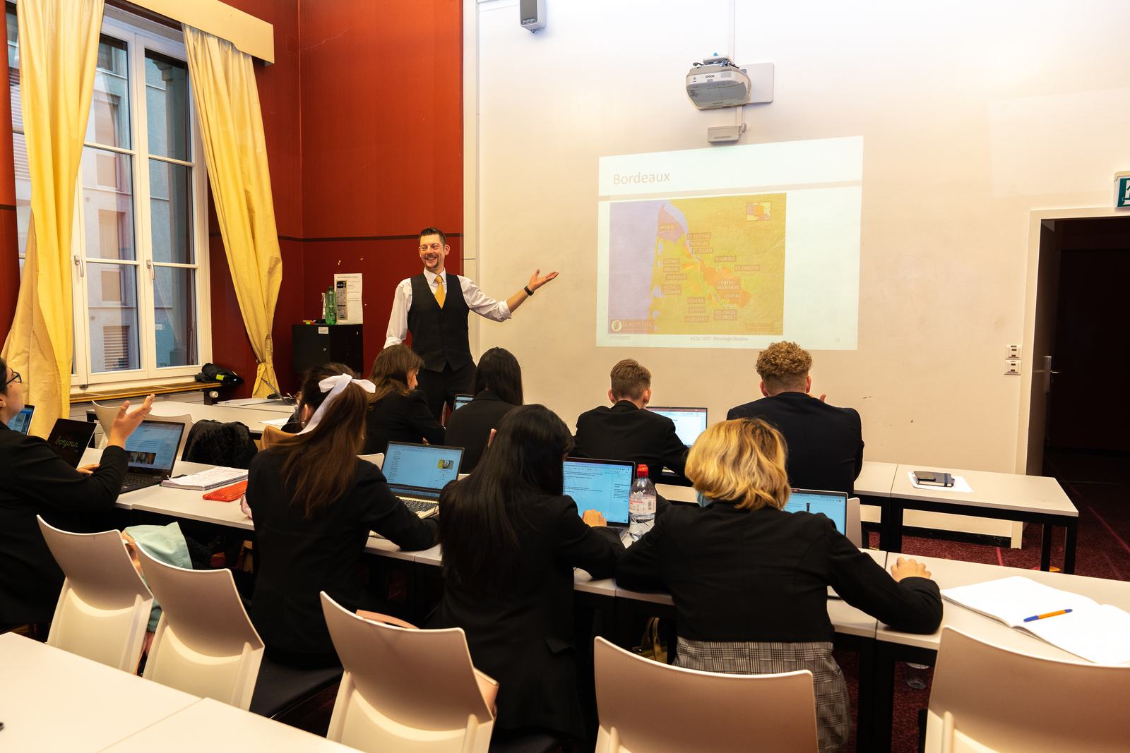 BHMS lecturer teaching a beverage studies class on the Bordeaux wine region
